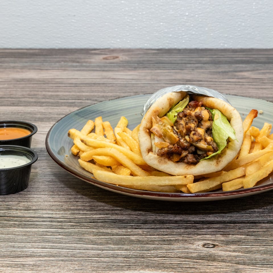 Lamb gyro served with fries and dipping sauces.