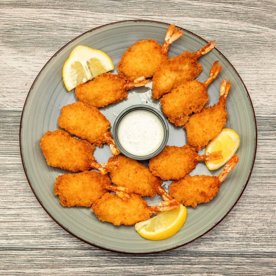 Breaded jumbo shrimp served with lemon and dipping sauce.