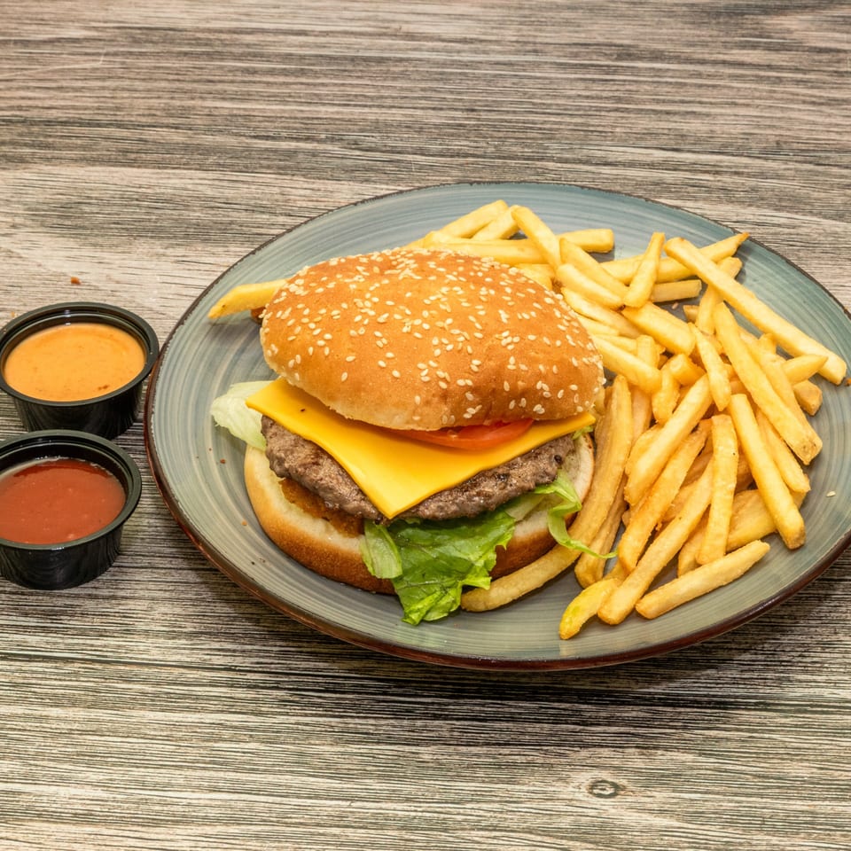 Cheeseburger with fries and dipping sauces.